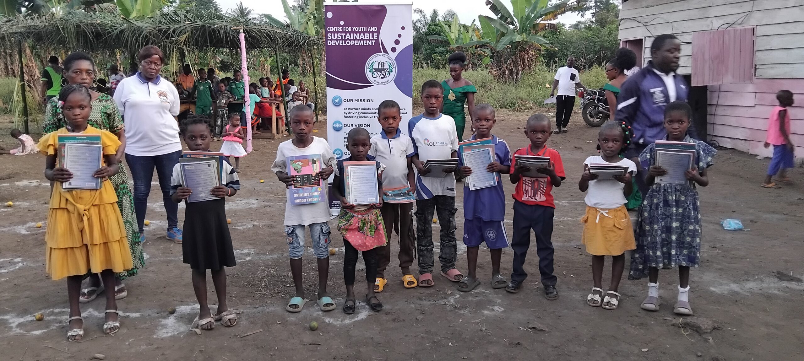 cysd-textbook-donation-munyenge Children receiving textbooks as donation